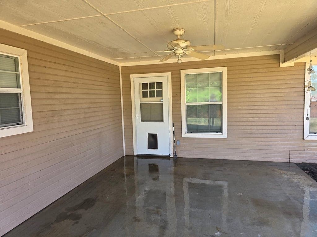 Clean, freshly washed covered patio with wet concrete floor