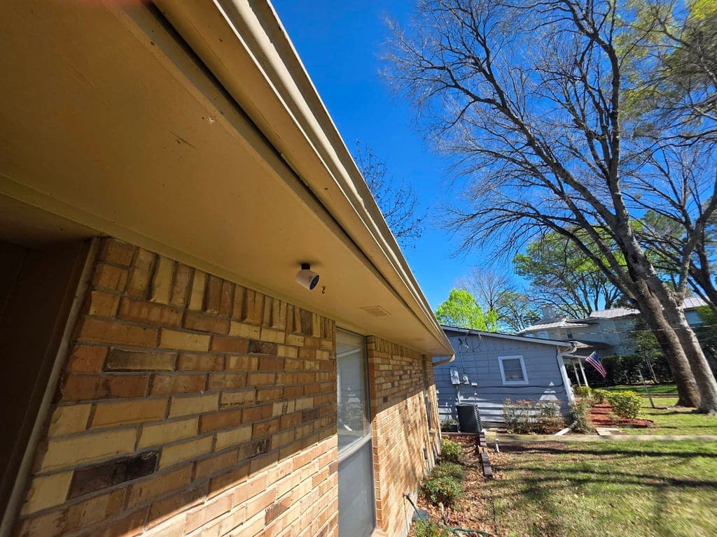 Bright, clean eave and soffit with gutter after dewebbing and wash